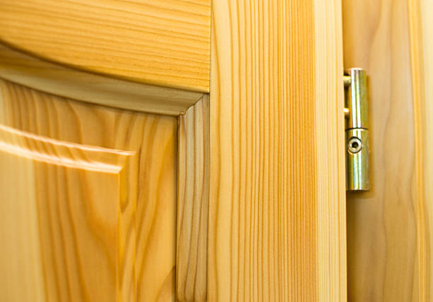 Golden barrel hinge on the wooden door Golden barrel hinge on the new wooden door in the joiner's shop life stile stock pictures, royalty-free photos & images