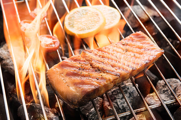 istock Grilled salmon with lemon on the flaming 490940056
