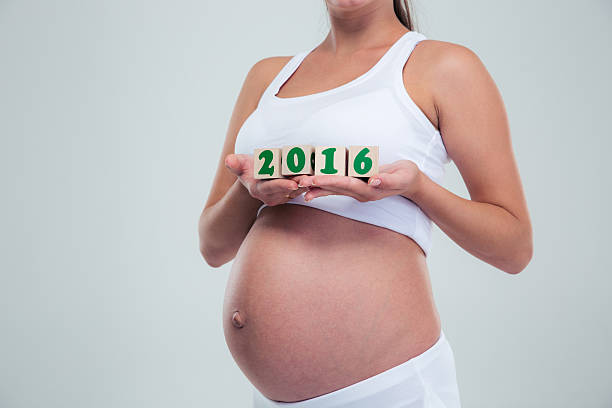 istock Pregnant woman holding number bricks 490943146