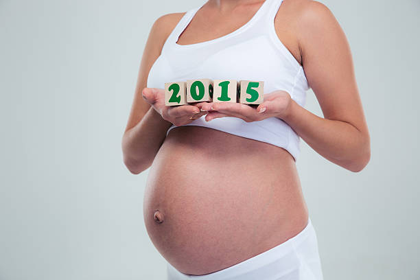 istock Pregnant woman holding number bricks 490943176