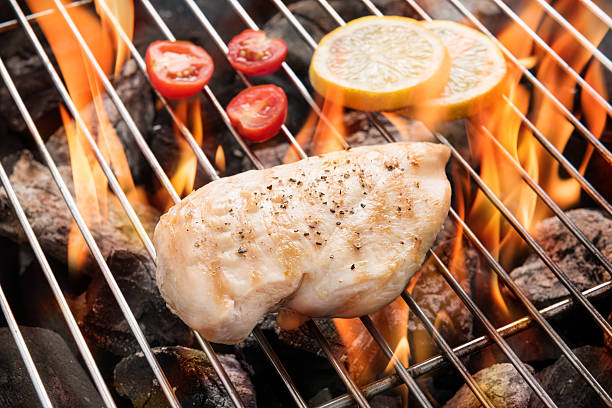 istock Grilled chicken breast on the flaming grill 490943304