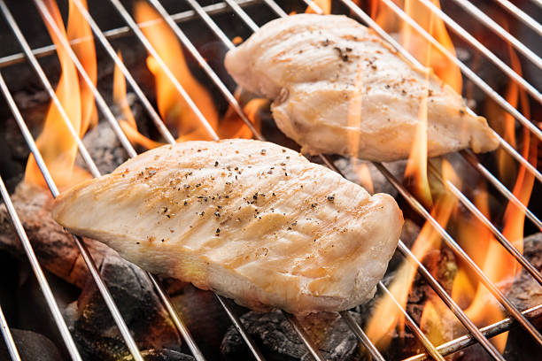istock Grilled chicken breast on the flaming grill 490943474