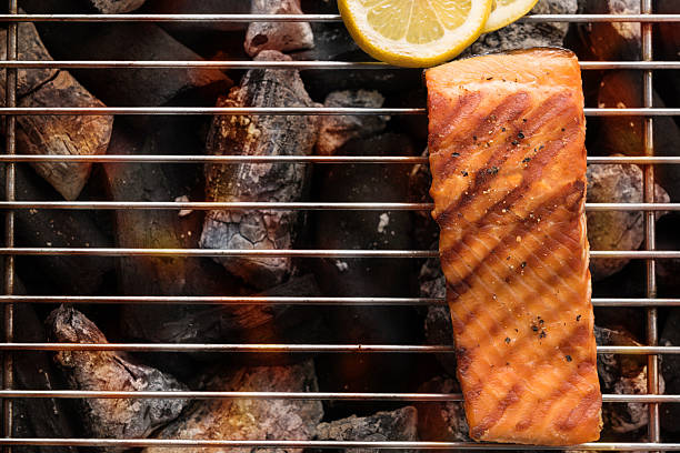 Grilled salmon with lemon on the flaming.