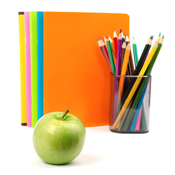 istock Copybooks with fresh apple and crayons 490958606