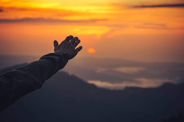 istock Touch the Sky concept Man Hand and Sunset Travel Lifestyle 490959140