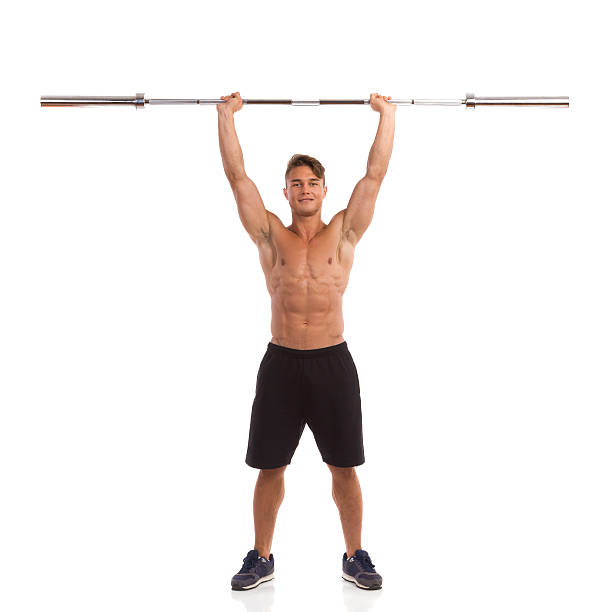 istock Fit Man Holding Barbell Over His Head 490960094