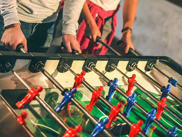 istock Young people playing foosball 490964966