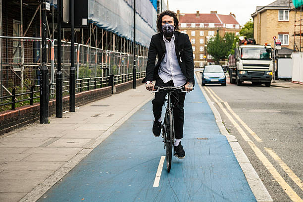 istock Cyclist commuter wearing a pollution-mask in Central London 490965956