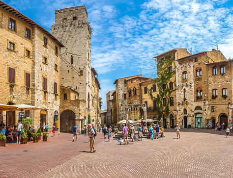 Panoramic view of famous Piazza della Cisterna in the historic town of  San Gimignano on a sunny day, Tuscany, Italy