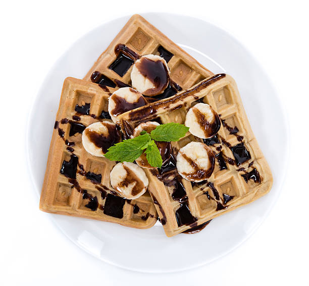 istock Waffles with Bananas and Chocolate Sauce (over white) 490968004