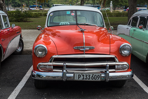 Havana, Cuba - September 28, 2015: Classic american car park on street of Old Havana,Cuba. Classic American cars are typical landmark and tourist attraction for whole Cuban island.