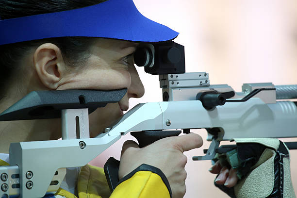 istock woman aiming a pneumatic air rifle 490969826