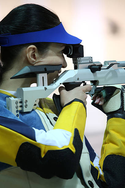 istock woman aiming a pneumatic air rifle 490969914