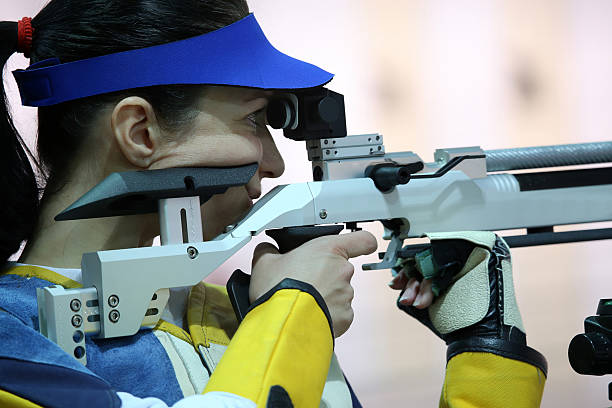 istock woman aiming a pneumatic air rifle 490970130