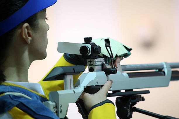 istock woman aiming a pneumatic air rifle 490970296