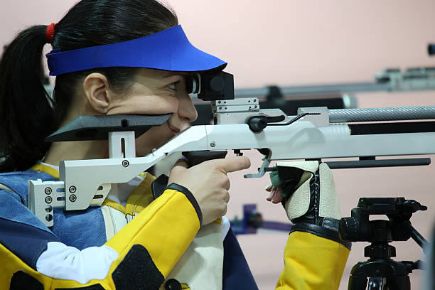 istock woman aiming a pneumatic air rifle 490970556
