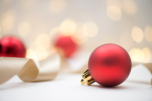 Red christmas baubles with shiny background , horizontal