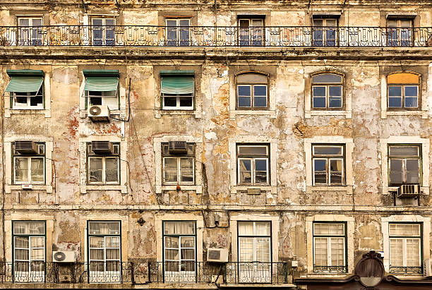 Old faded european house with wooden windows, Portugal