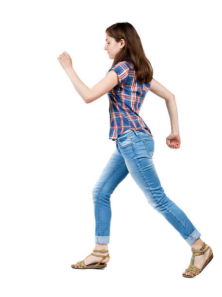 istock back view of running  woman in jeans 490973624