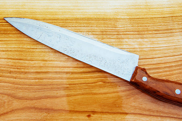 istock knife on an wooden cutting board 490985110