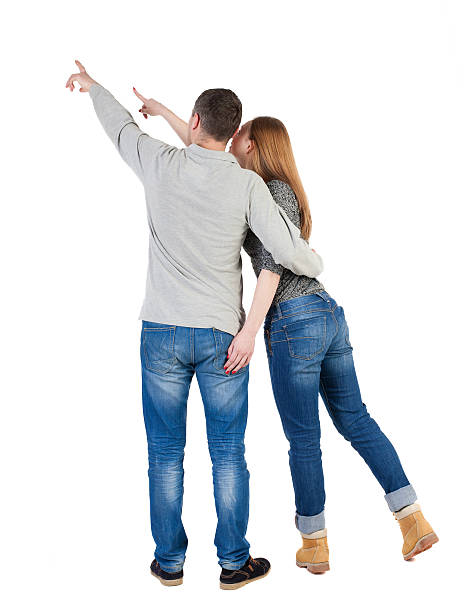 istock young couple pointing at wal Back view  (woman and man). 490985674