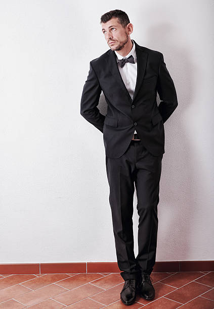 istock Man in tuxedo stands pensive at home before going out 490986162