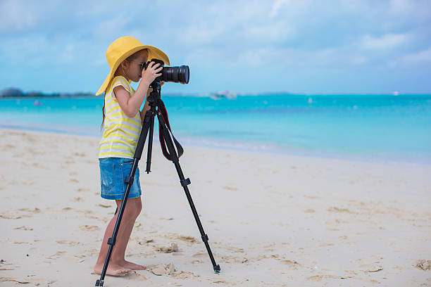 istock Little girl shooting with camera on during her summer vacation 490987403