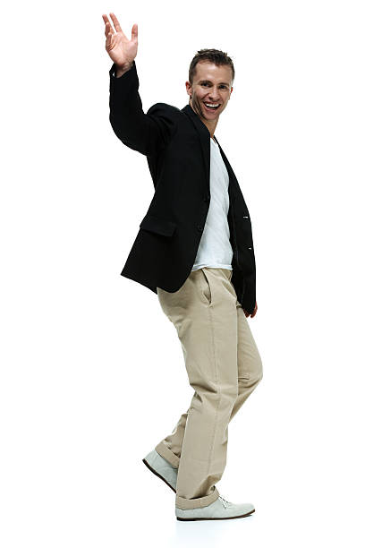 istock Cheerful smart casual man walking & waving hand 490989373