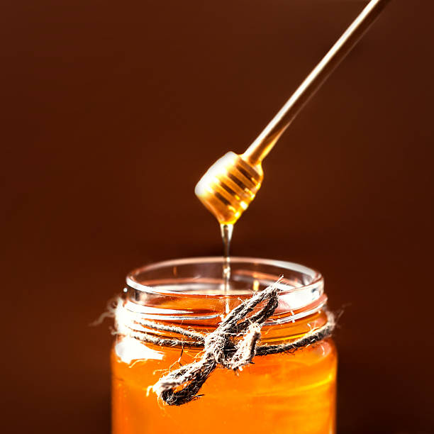 istock Fresh Honey in jar with  dipper on vintage 490990276
