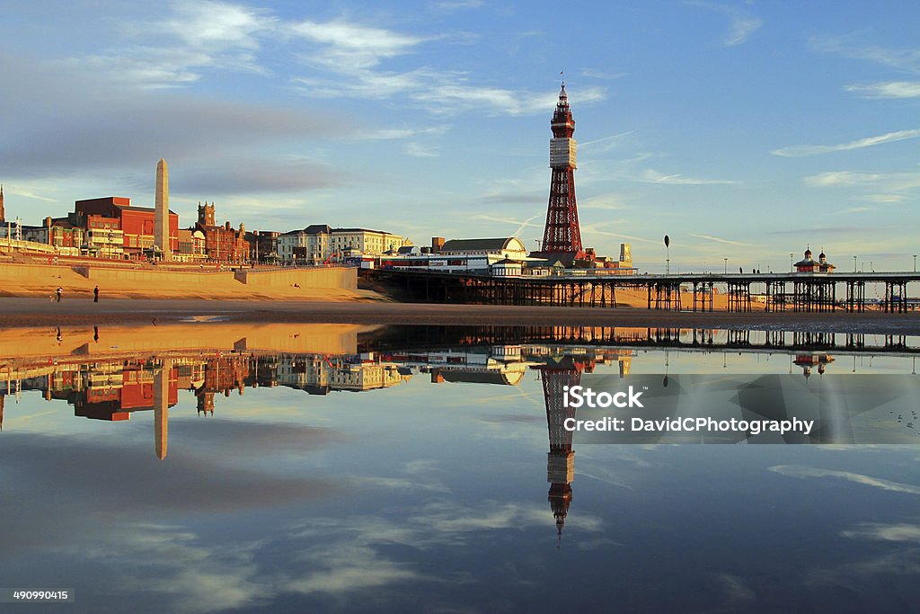 Blackpool Tower Reflection A Fylde Coast Golden Hour Reflection of Blackpool Tower and North Pier on a calm still early evening glow. Blackpool Stock Photo