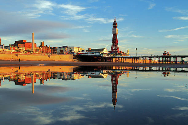 Blackpool Tower Reflection A Fylde Coast Golden Hour Reflection of Blackpool Tower and North Pier on a calm still early evening glow. lancashire photos stock pictures, royalty-free photos & images
