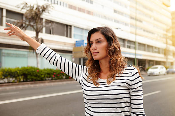 istock Beautiful woman hailing a cab during the day 490991098