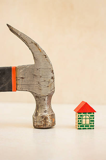 istock Hammer and miniature house 490992128