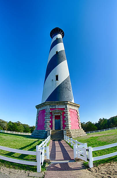 Diagonal black and white stripes mark the Cape Hatteras lighthou Diagonal black and white stripes mark the Cape Hatteras lighthouse at its new location near the town of Buxton on the Outer Banks of North Carolina lighthouse with red white stripes stock pictures, royalty-free photos & images