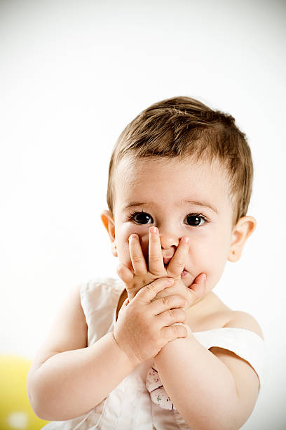 istock little girl covering her mouth 490993371