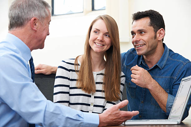 istock Couple Talking With Financial Advisor In Office 490993777