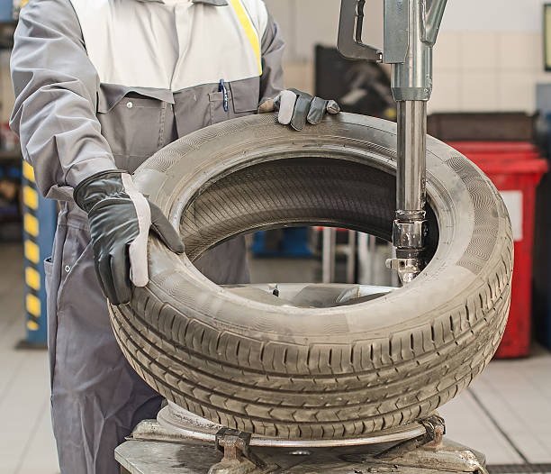istock Mechanic changing car tire with bead breaker tool. 490994083