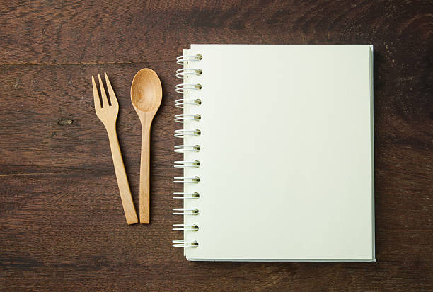 istock recipe book and spoon,fork on wooden table. 490997048