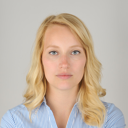 Official portrait of a blonde caucasian woman on a grey background. For use to travel to for instance India.