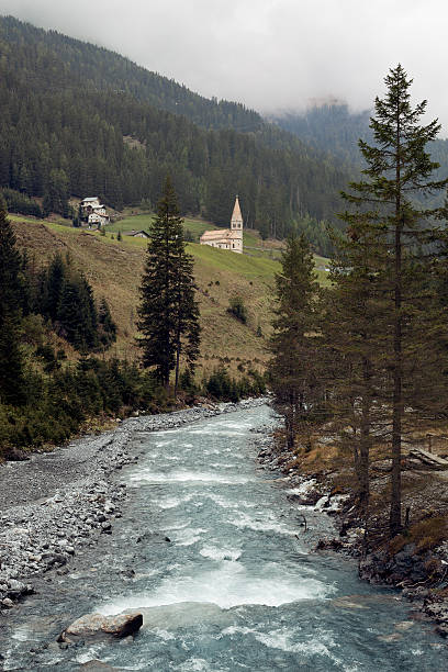 Trafos. A beautiful little mountain village in South Tyrol. This view shows a beautiful river and the small church of Trafoi.