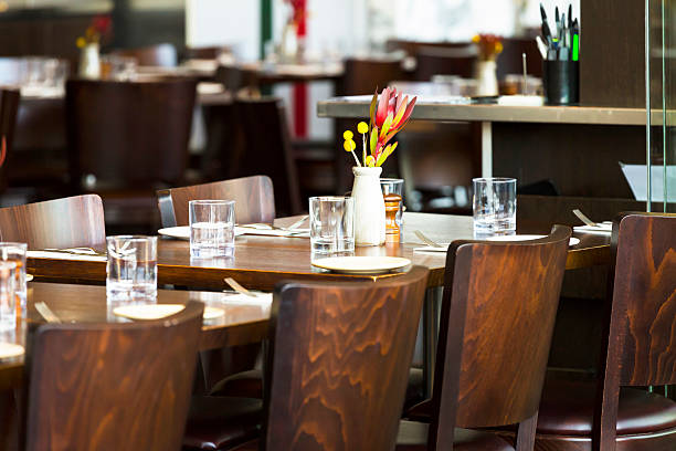 istock Interior of restaurant with table setting and vase with flowers 491023906