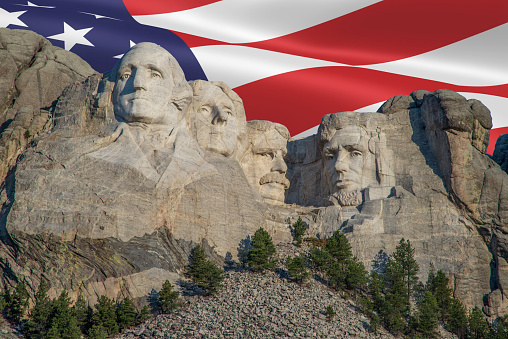 Carvings of Presidents Washington, Jefferson, Roosevelt and Lincoln with United States flag
