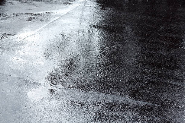 istock puddles of water on a pavement after rain 491044952
