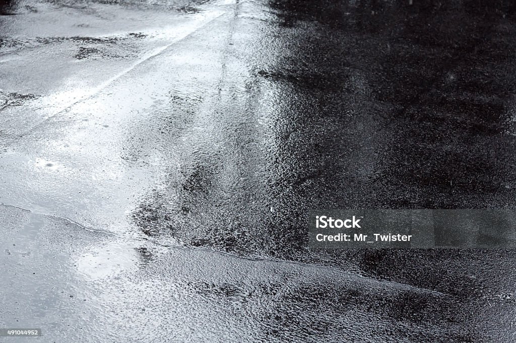 puddles of water on a pavement after rain wet asphalt sidewalk background after heavy rain Asphalt Stock Photo