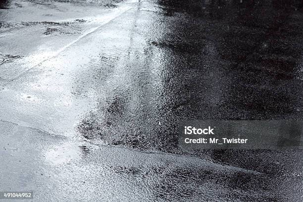 Puddles Of Water On A Pavement After Rain Stock Photo - Download Image Now - Asphalt, Wet, 2015