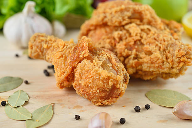 istock fried chicken isolated on wooden  background 491046018