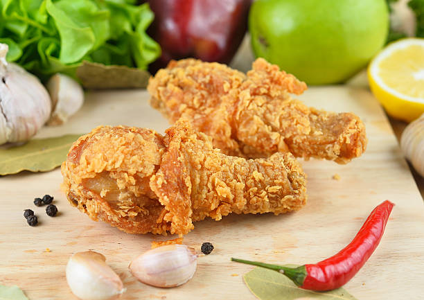 istock fried chicken isolated on wooden  background 491046066