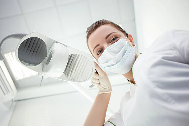 Attractive female dental doctor is working in her office stock photo