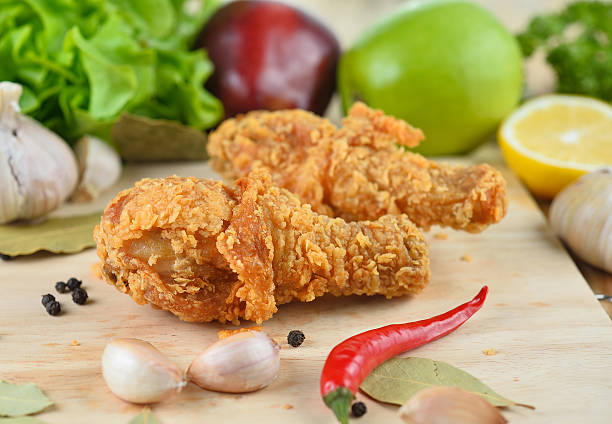 istock fried chicken isolated on wooden  background 491046894
