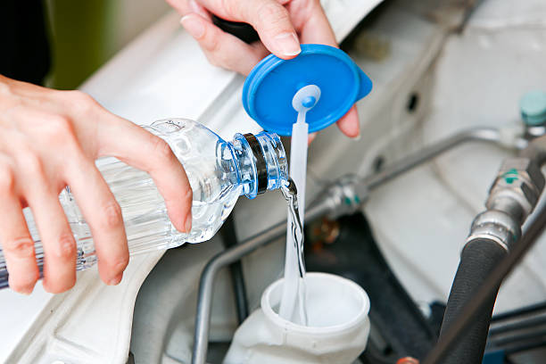 istock Fill the windshield water liquid on a car. 491055746